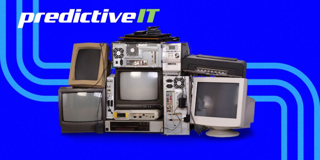 "Stack of outdated computer monitors and hardware representing legacy systems and IT modernization by predictiveIT"