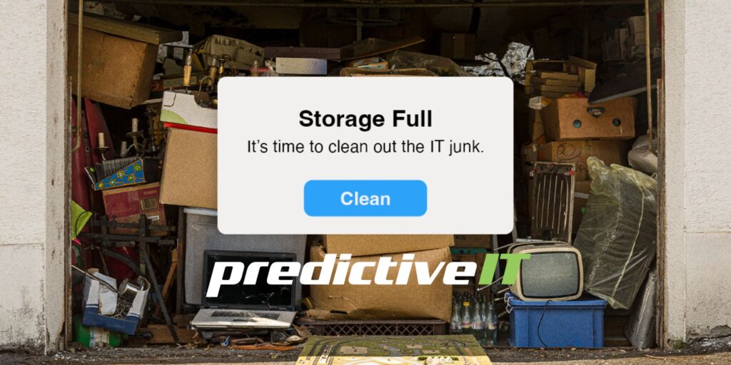 Cluttered garage full of boxes and old electronics with a pop-up saying “Storage Full – Clean out IT junk,” representing digital storage cleanup by predictiveIT.