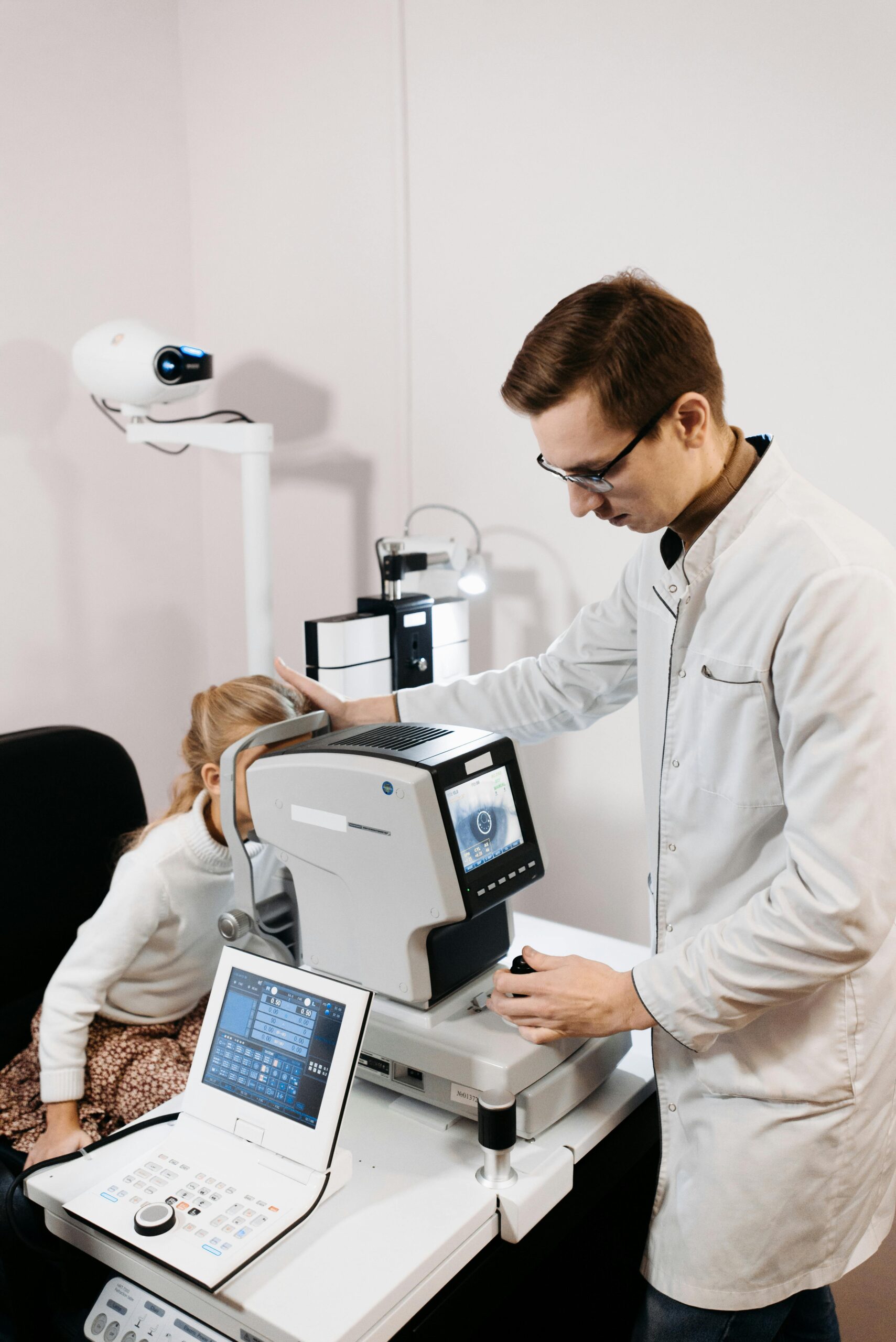 "Doctor performing eye scan with advanced diagnostic equipment supported by secure healthcare IT solutions from predictiveIT"