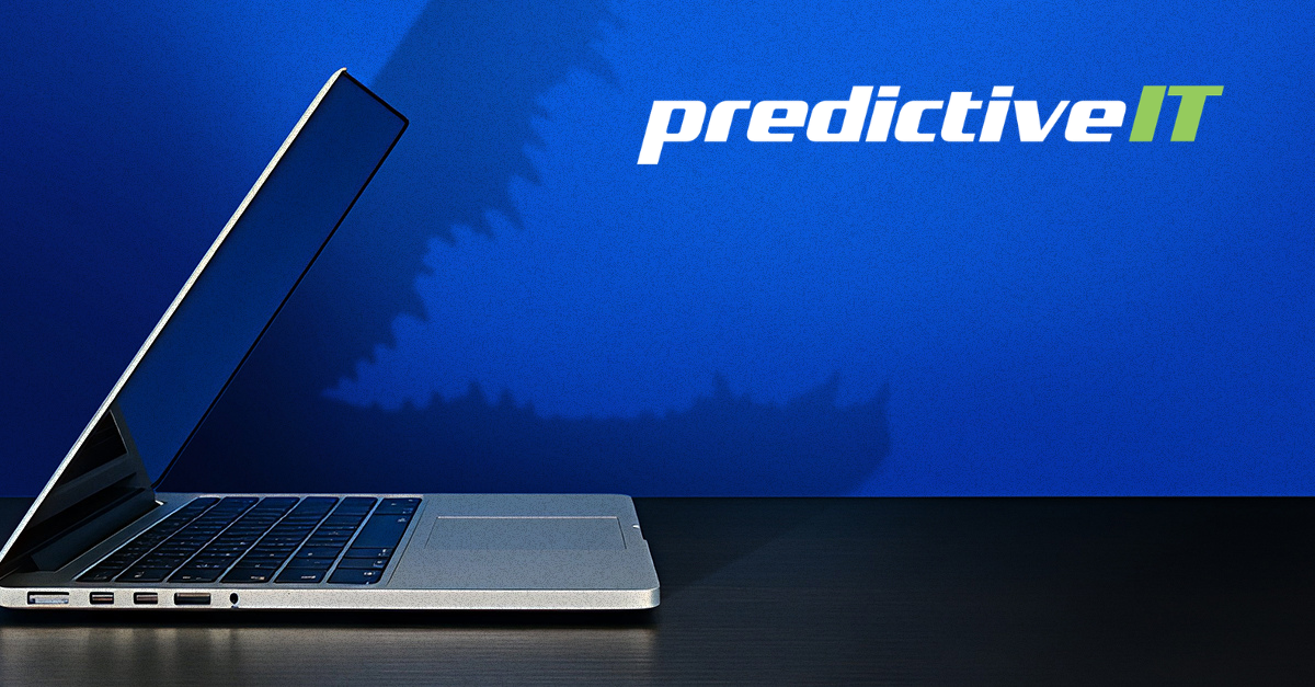 Laptop on a desk with a large saw blade shadow in the background, symbolizing hidden cybersecurity threats, technology risks, and the importance of proactive IT management. The predictiveIT logo appears in the upper corner.